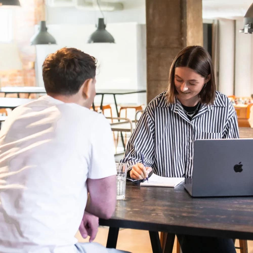 Image of two employees holding a meeting